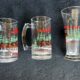 Vintage 1989 Budweiser and Coca Cola Christmas Edition mugs and glasses.